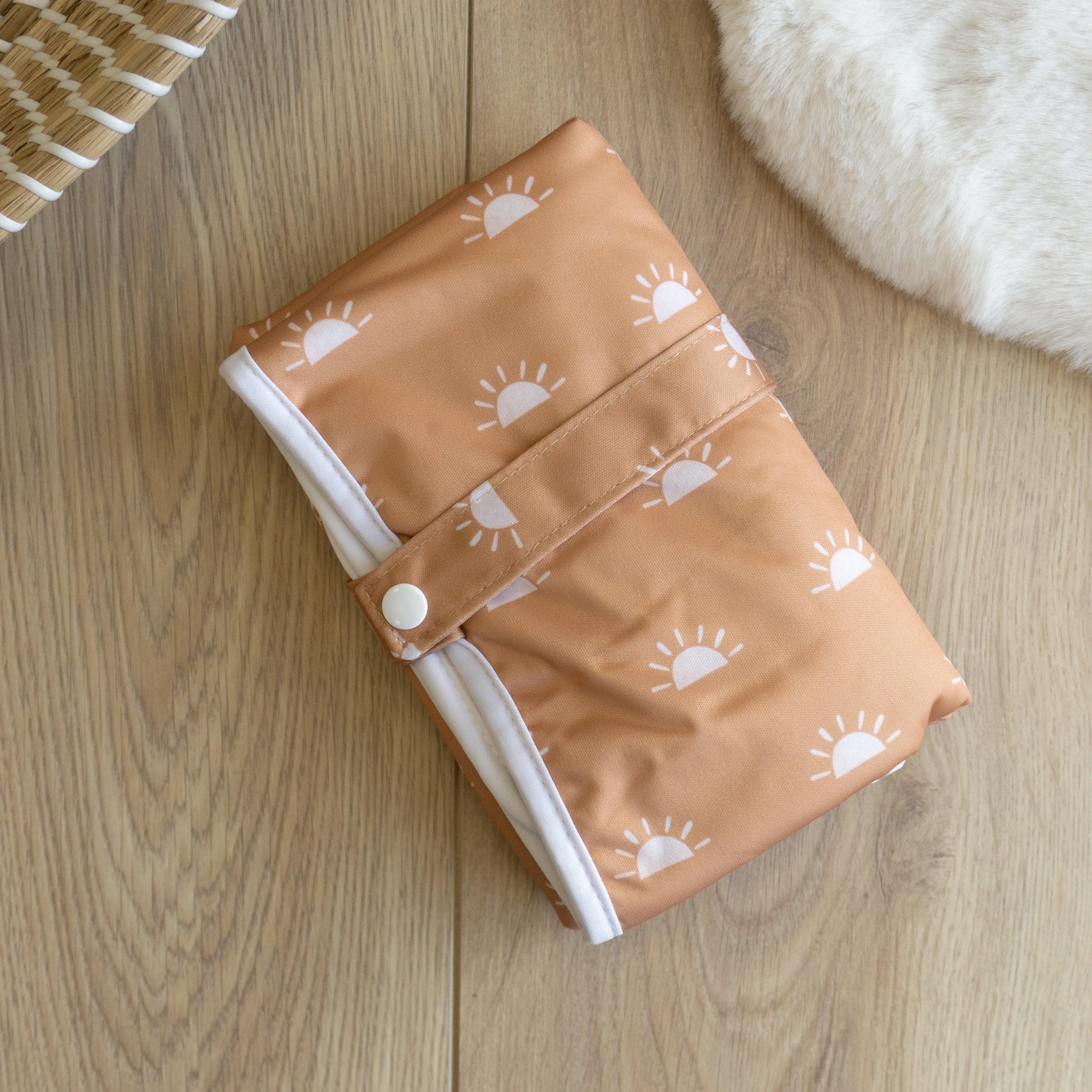 reusable baby changing mat portable / travel - pattern tan base with white suns. Unisex neutral